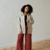 Model wearing utility jacket and trousers in natural linen