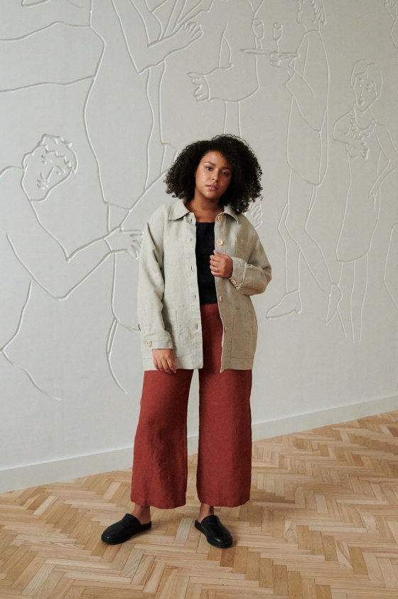Model wearing utility jacket and trousers in natural linen