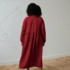 model wearing loose fit linen dress in red color