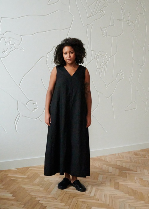 Front of a model in a long black sleeveless linen dress