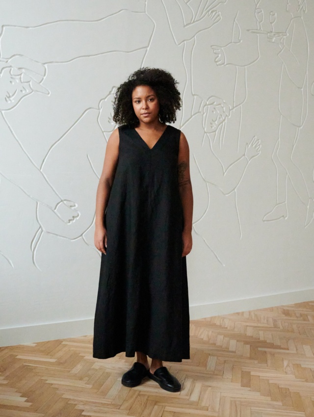 Front of a model in a long black sleeveless linen dress