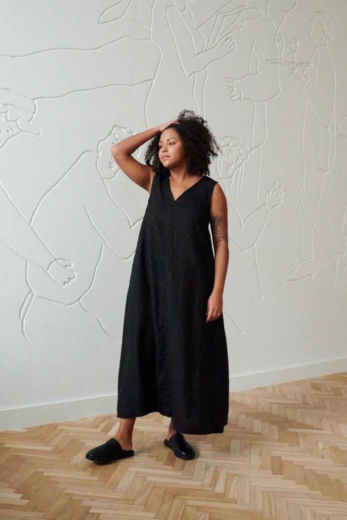 Model in a long black linen dress