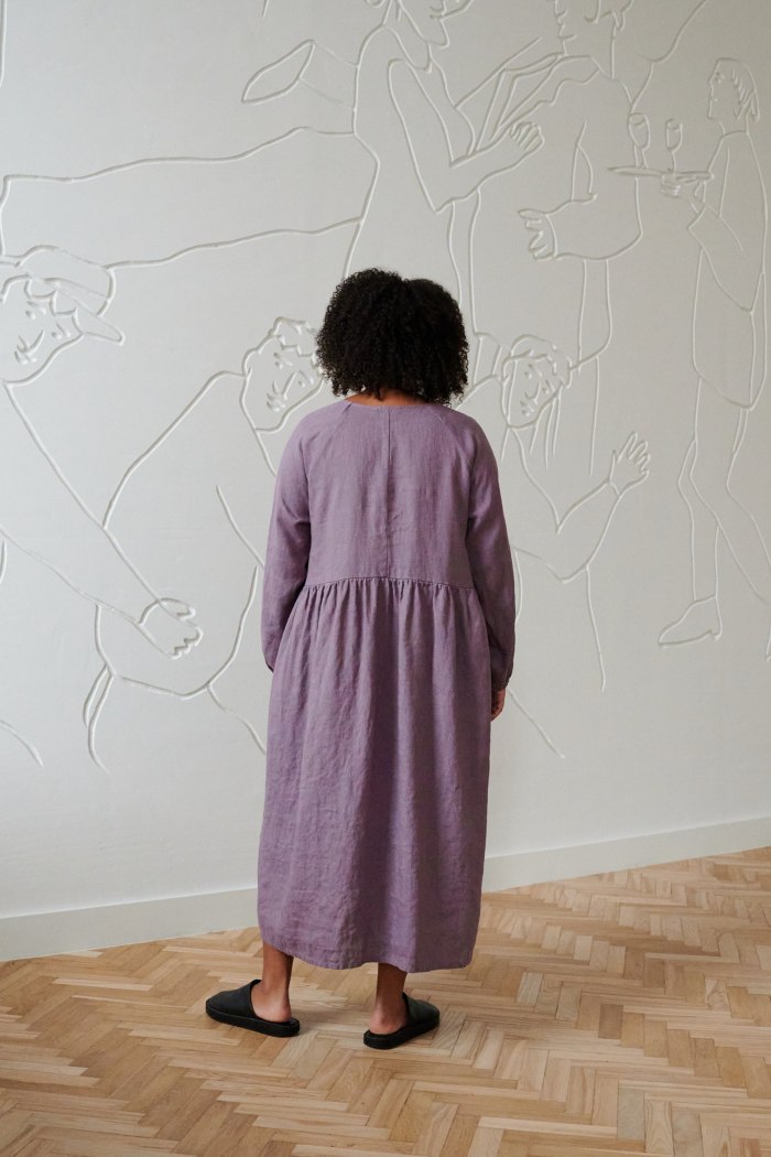 Model wearing soft linen dress in dusty lavender color