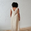 A long sleeveless linen dress with a V neckline in the back
