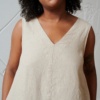 A beige sleeveless linen dress with a V neckline