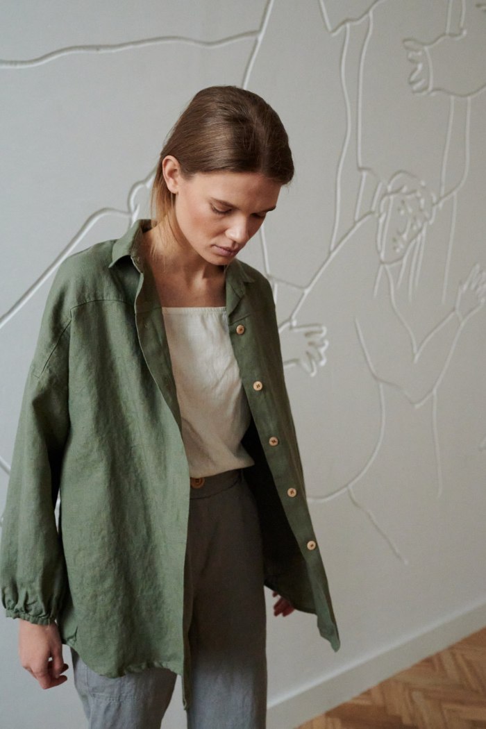 model wearing green organic linen shirt