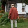 Back of an oversized terracotta linen shirt with unbuttoned long sleeves