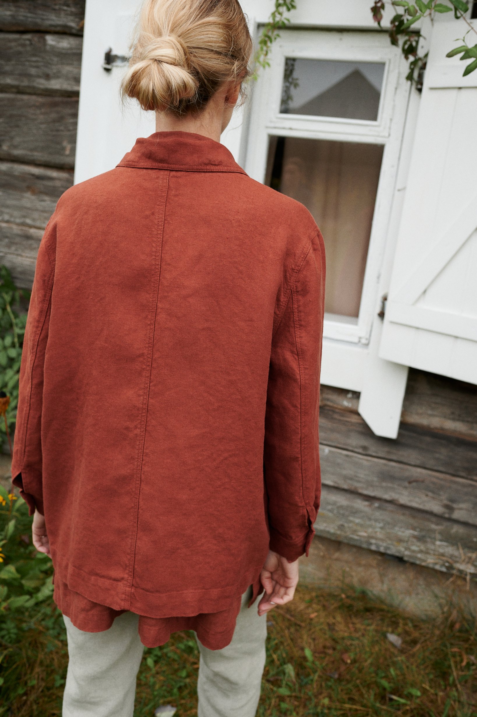 Back view of a model wearing a relaxed fit heavy linen jacket