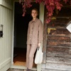 Model holding a heavy linen tote bag in natural grey