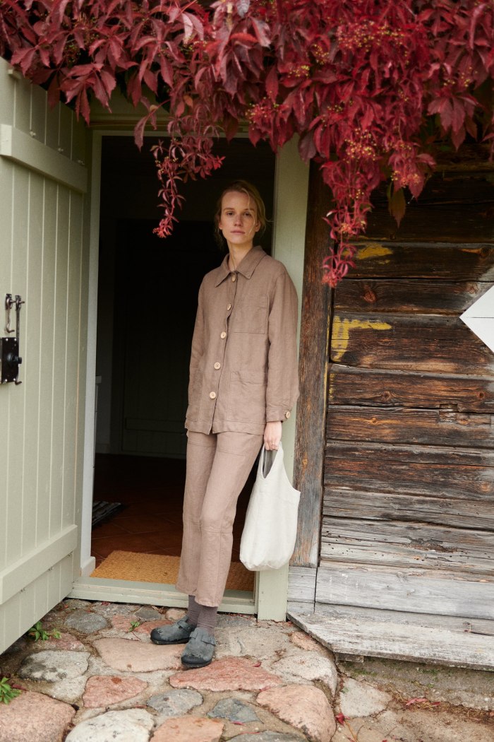 Model holding a heavy linen tote bag in natural grey