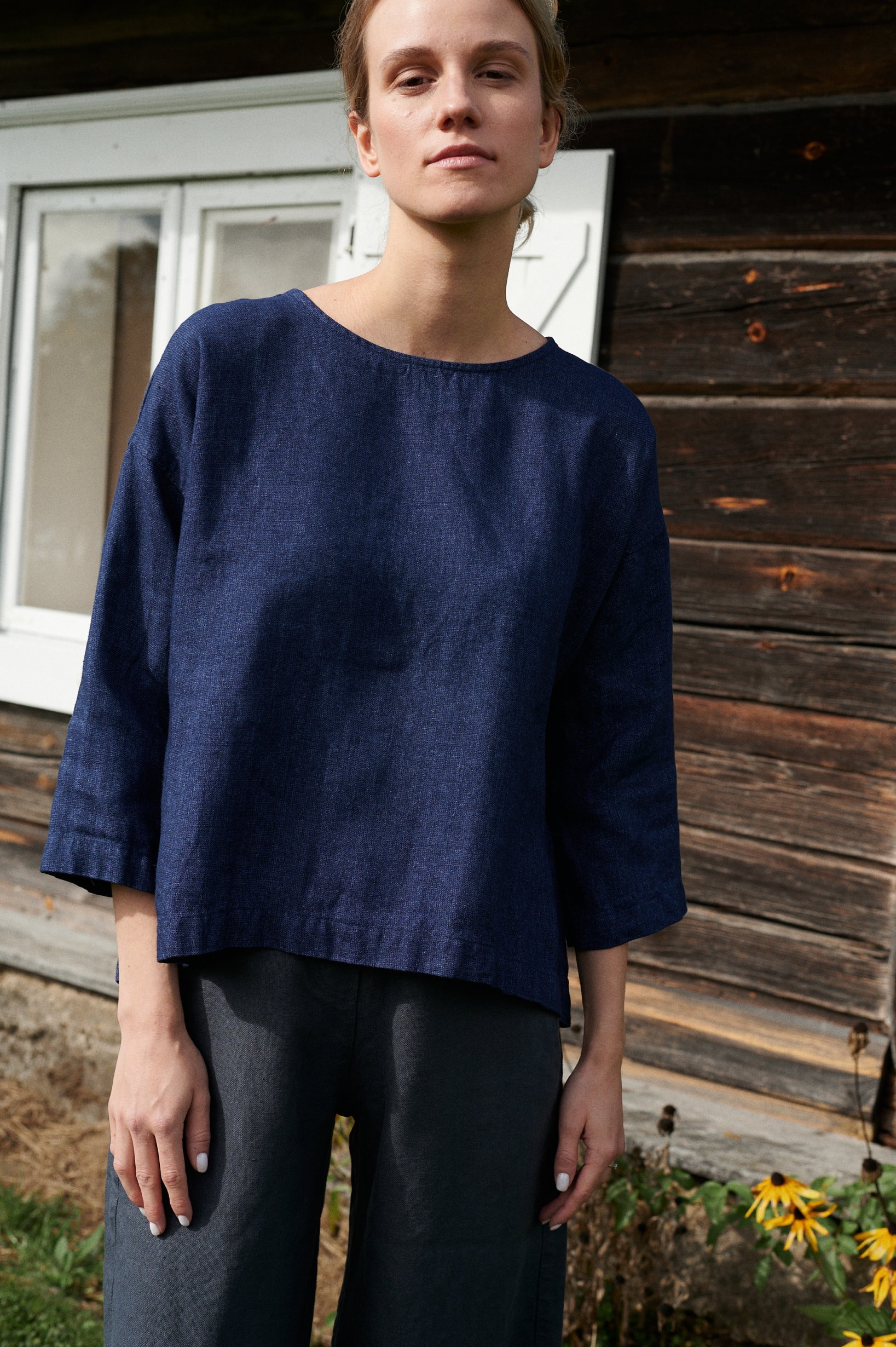 Relaxed navy blue linen top with a flared high-low hem and three-quarter sleeves