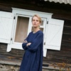 A woman wearing long sleeve wool blend dress in navy blue