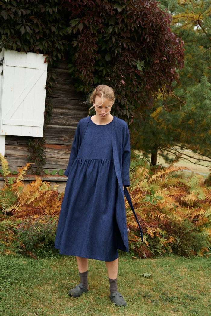 A model wearing long oversized linen wool dress in dark blue