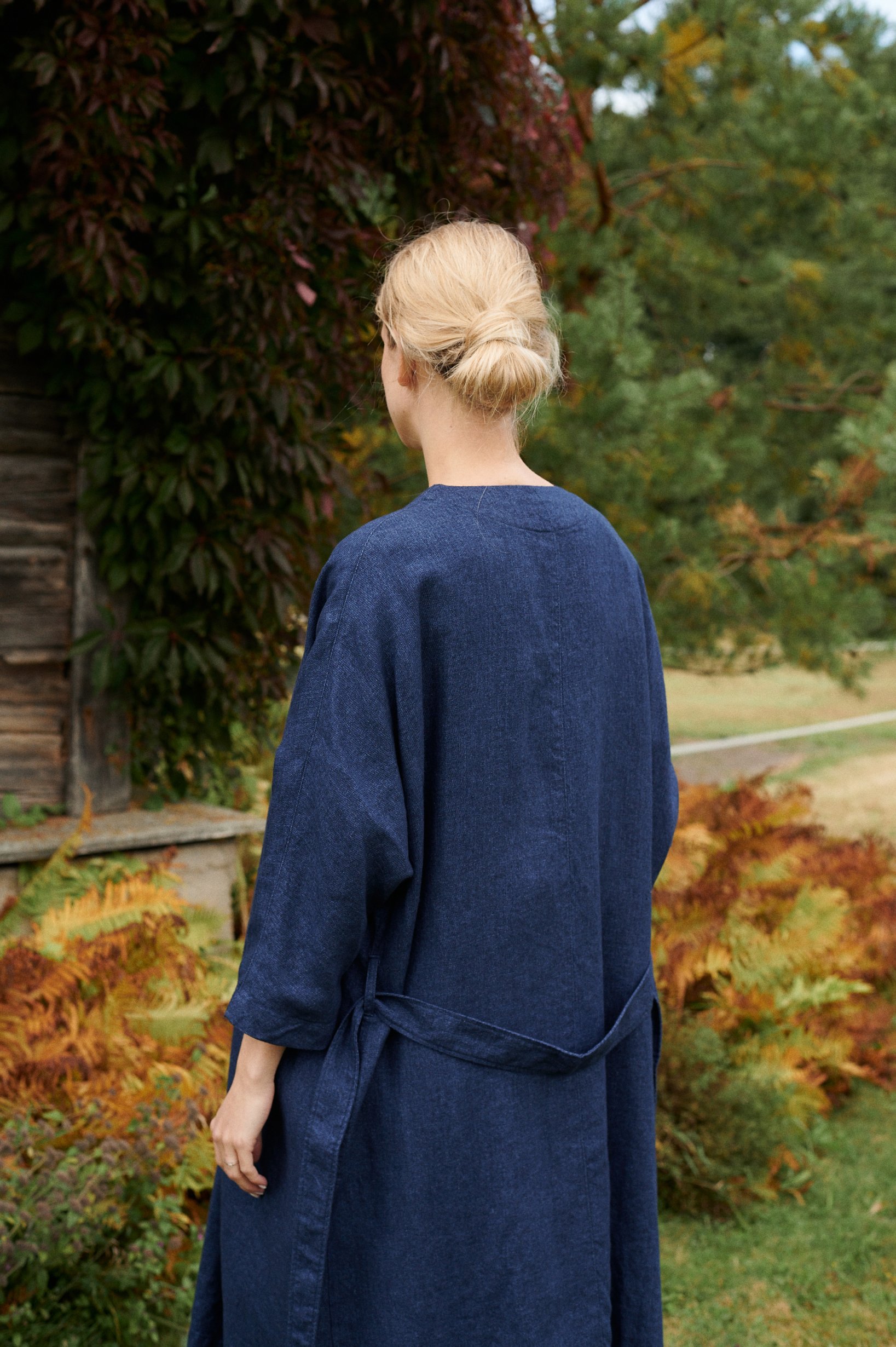 Back view of a woman in a navy blue linen wool blend jacket