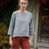 Woman in a grey linen wool blend tunic and linen pants