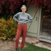 A model in a grey linen wool blend tunic and terracotta linen trousers