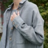 A woman in oversized linen wool blend grey shirt