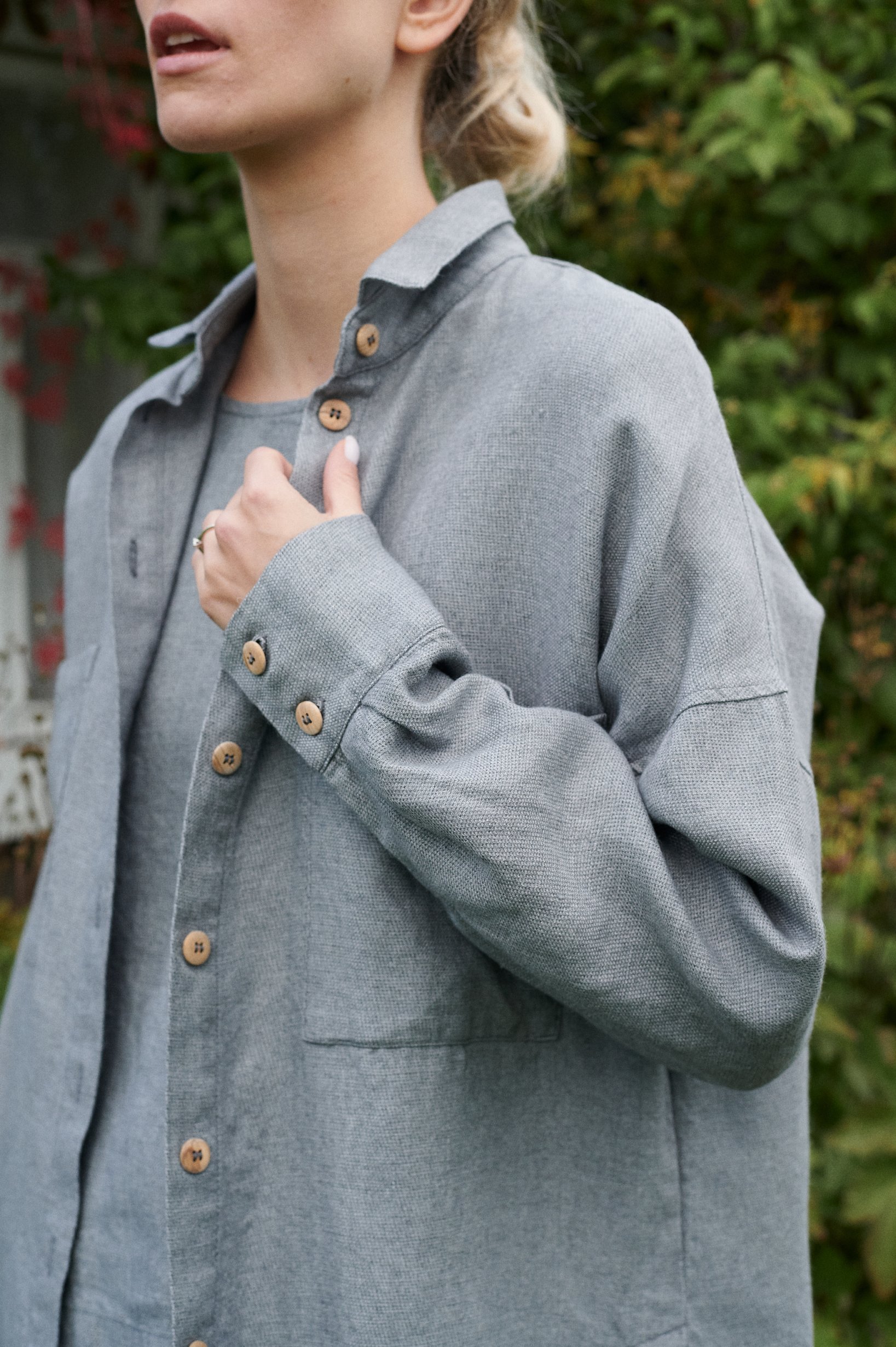 A woman in oversized linen wool blend grey shirt