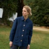 Front of a blue heavy linen utility jacket with wooden buttons and pockets