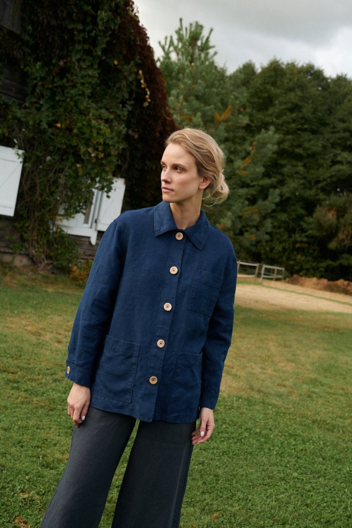 Front of a blue heavy linen utility jacket with wooden buttons and pockets