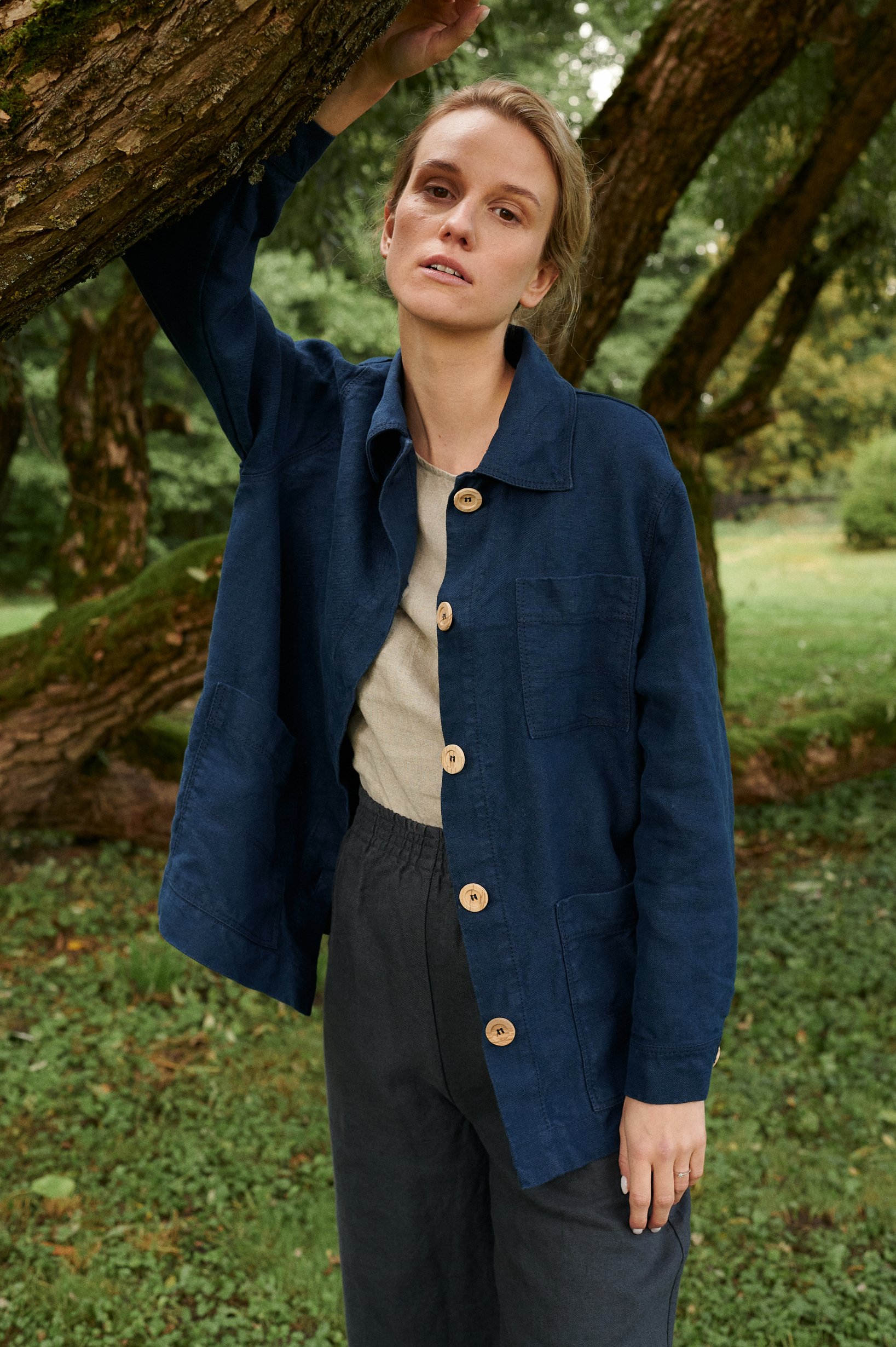 Model in blue jacket and utility linen pants set