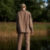 Back of a model wearing a brown linen utility jacket and pants