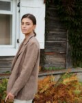 Side view of a model wearing a cacao heavy linen blazer with notch lapels