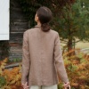 Back view of a model wearing a relaxed fit heavy linen blazer and linen trousers