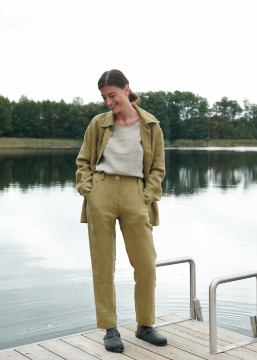 Heavy linen utility jacket and trousers outfit with a tucked in linen shirt