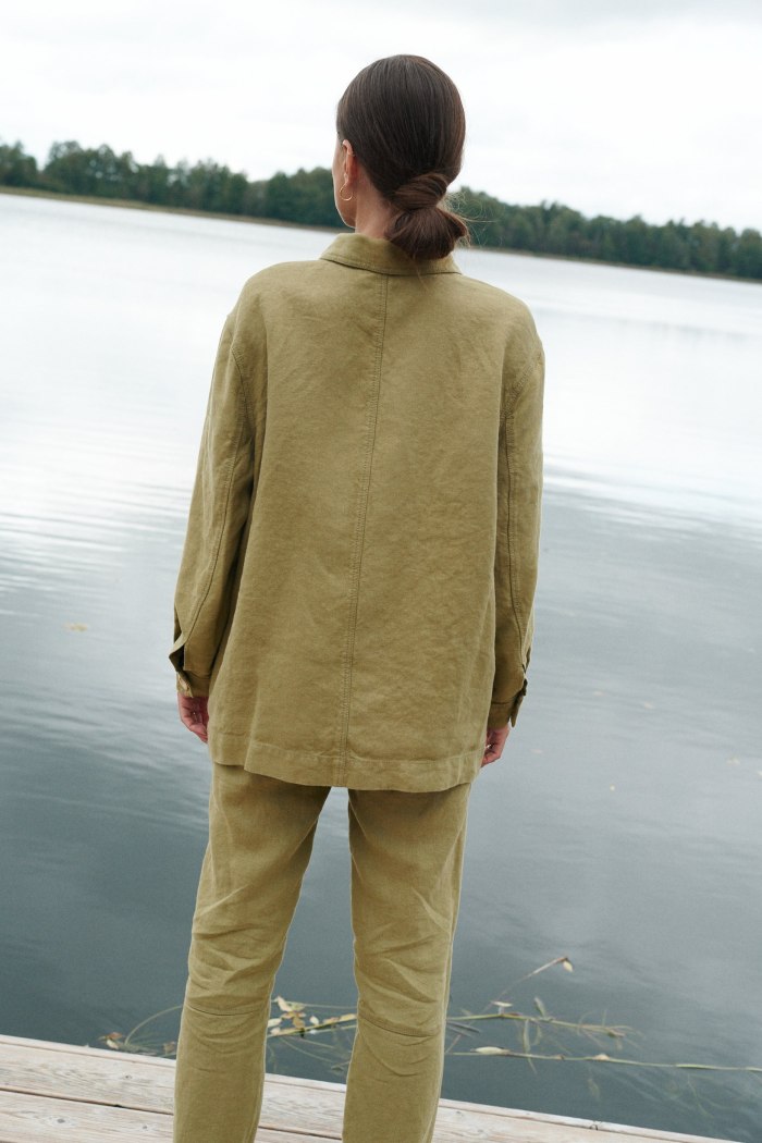 Back of a model wearing a heavy linen utility jacket and pants