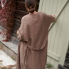 Back of a long relaxed fit brown linen jacket