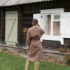 Back of a long heavy cacao linen jacket tied with a belt