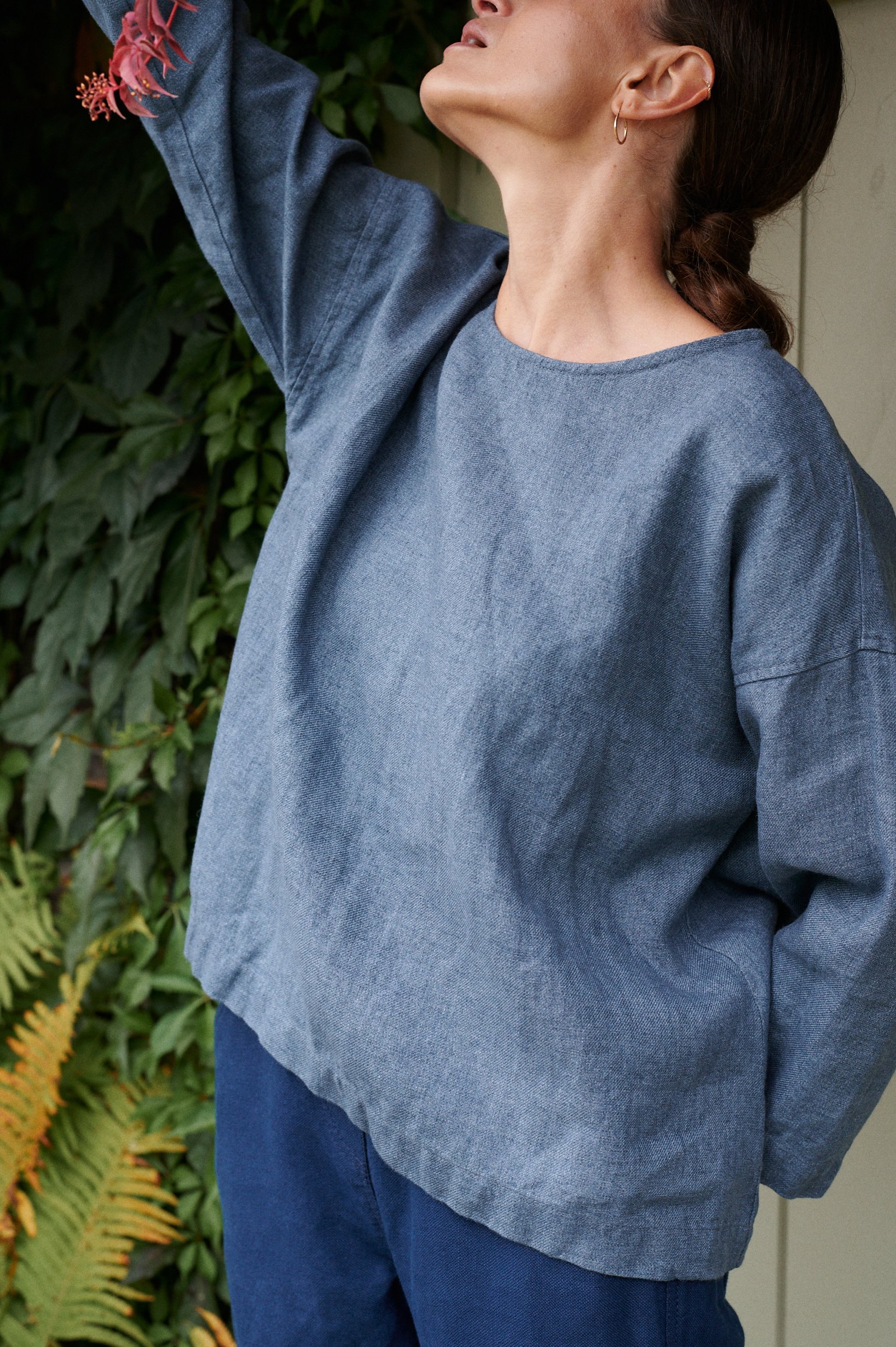 Front of a blue linen wool blend tunic with a flared high-low hem and three-quarter sleeves with a flared high-low hem and three-quarter sleeves