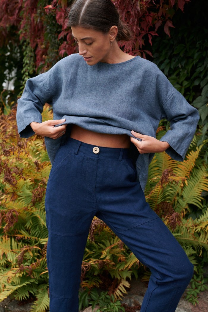 High-waisted blue utility linen trousers with a wooden button and side pockets