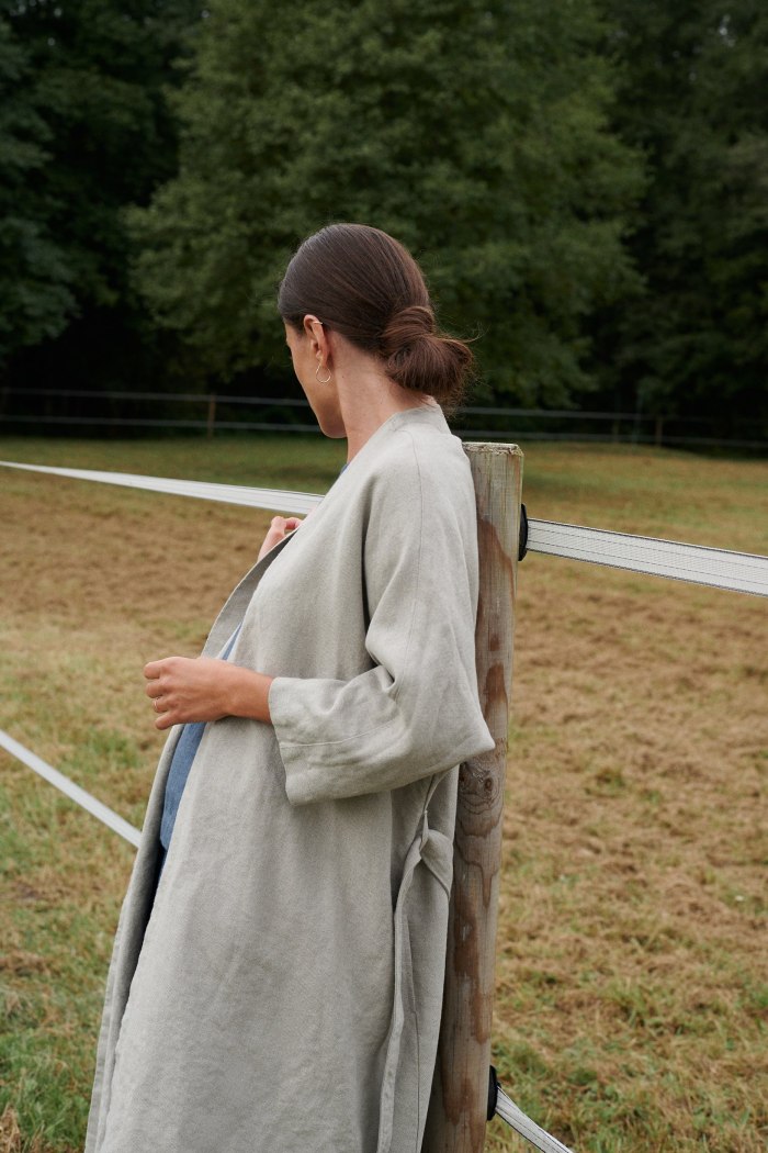 Side view of a long grey linen jacket unfastened