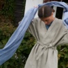 A long heavy natural grey linen jacket paired with a linen scarf