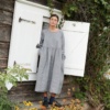 A woman wearing oversized smock dress in grey linen wool blend