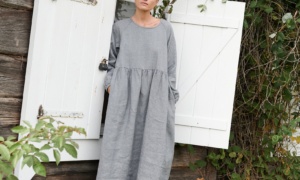 A woman wearing oversized smock dress in grey linen wool blend