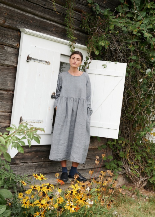 A woman wearing oversized smock dress in grey linen wool blend