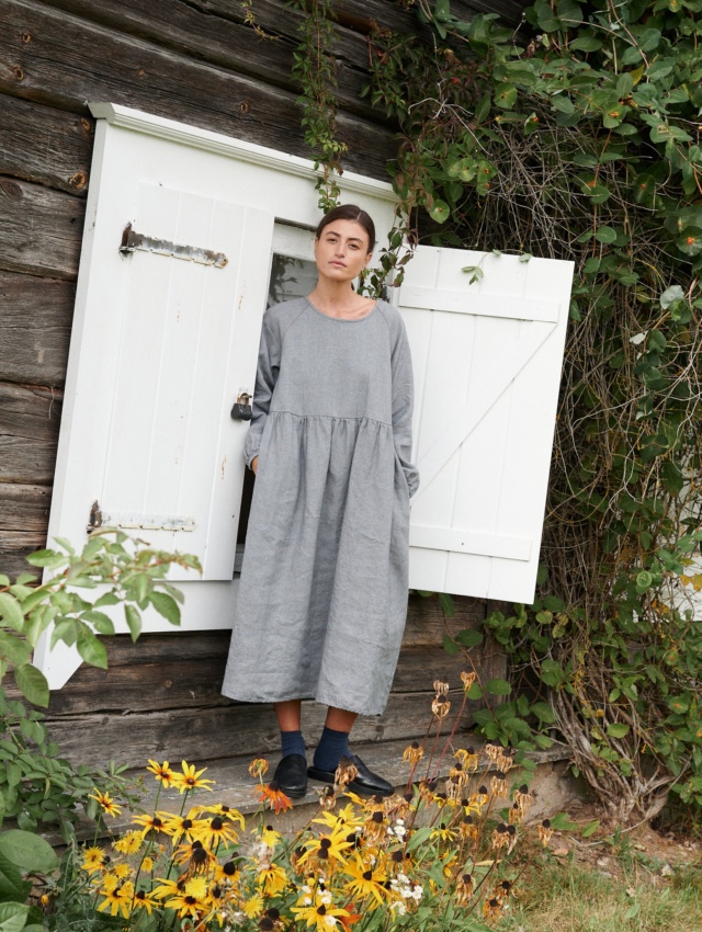 A woman wearing oversized smock dress in grey linen wool blend