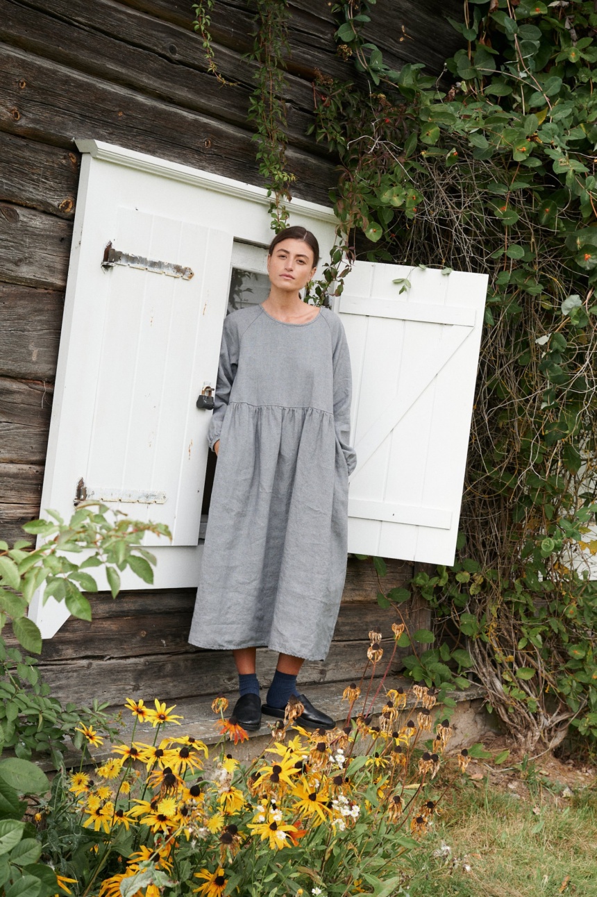 A woman wearing oversized smock dress in grey linen wool blend