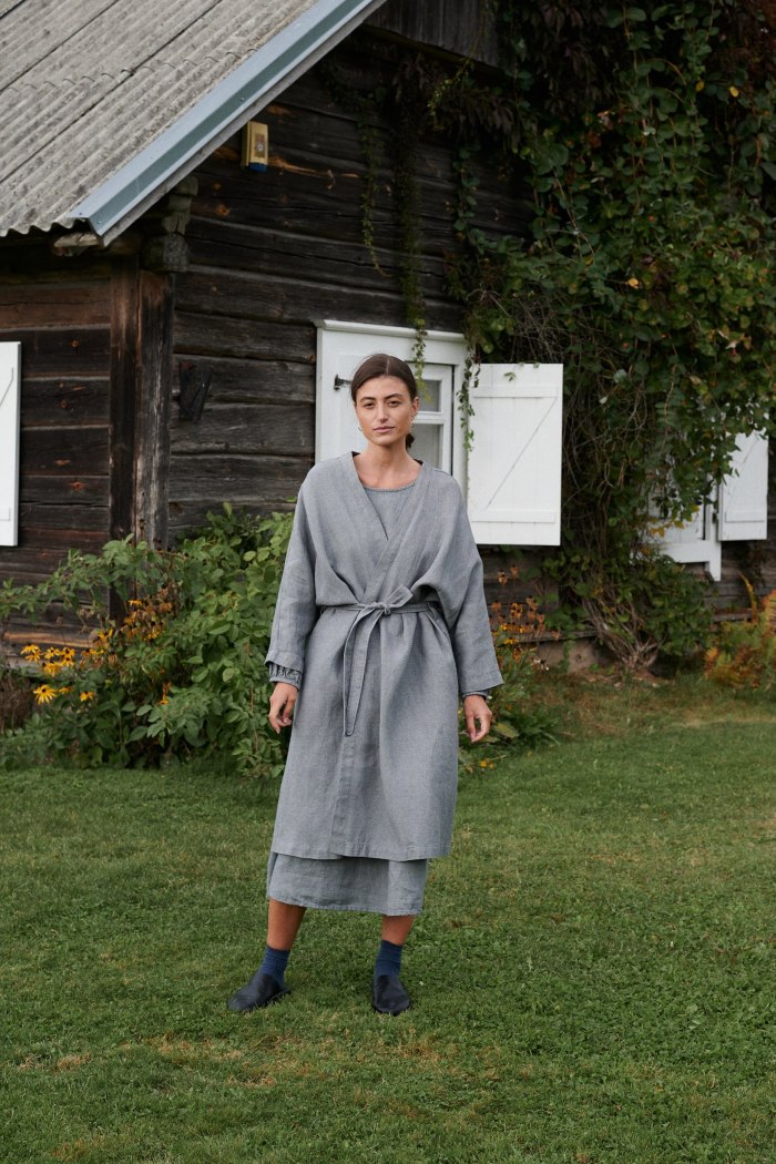 Model in a grey linen wool blend oversized jacket with a matching belt