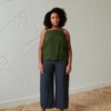 Front of a model in a linen summer top with thin straps and wide leg linen trousers outfit
