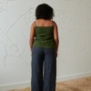Back of a model wearing a casual strapless linen top and and wide leg linen trousers