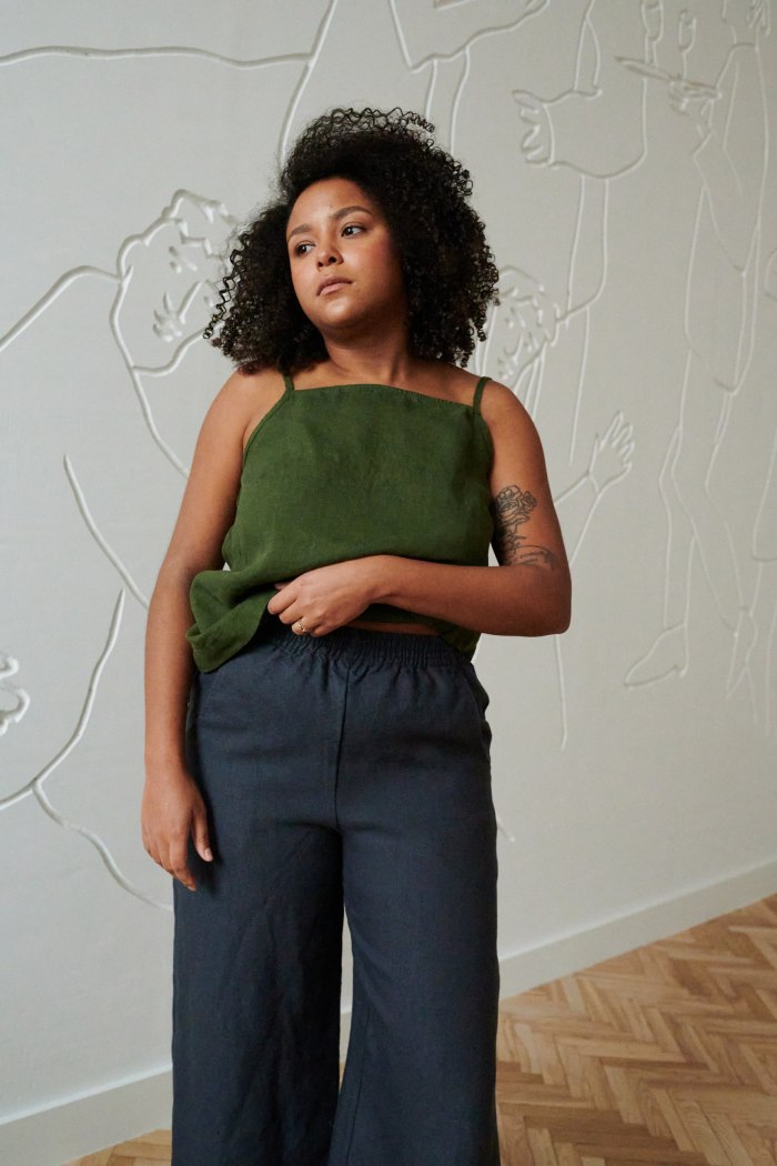 A model in a casual straight-cut linen top and linen pants outfit