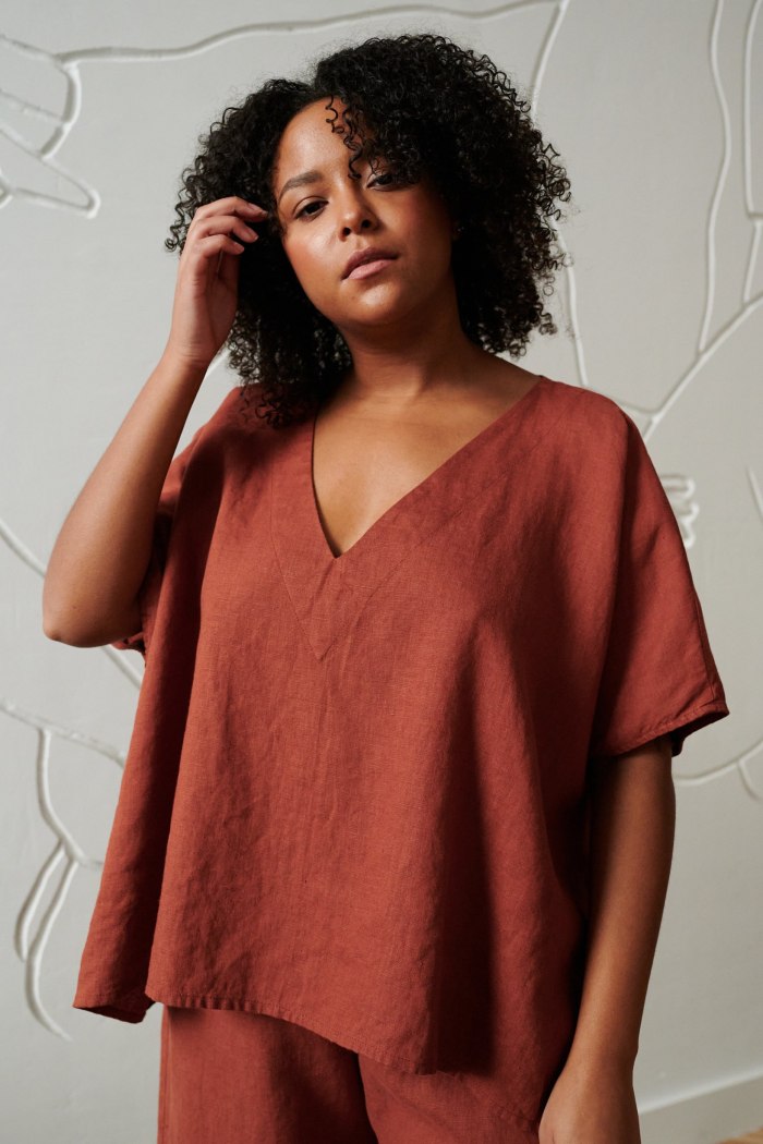 Model in a one-size-fits-all boxy top with a V neckline