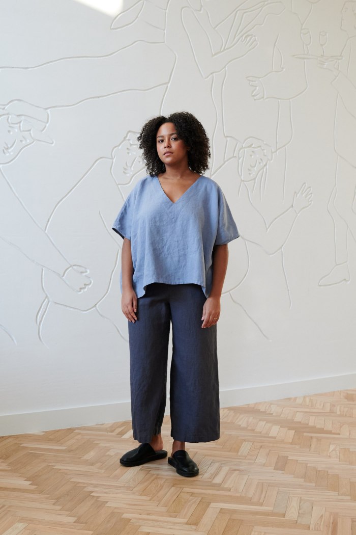 A model in V-neck oversized blue linen top