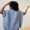 Back of a loose-fitting linen top in sky blue color