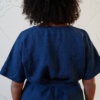 Back of a linen jumpsuit fastened with an attached belt