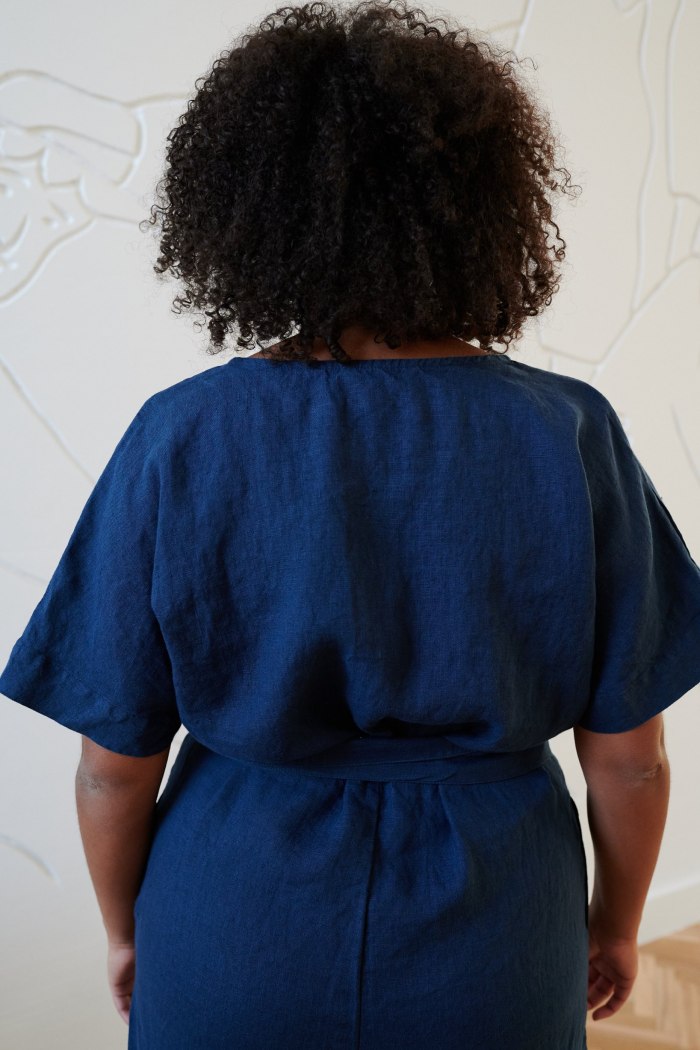 Back of a linen jumpsuit fastened with an attached belt